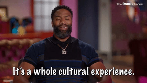 Cupcake Wars personality waving arms and saying It's a whole cultural experience. 