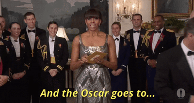 Michelle Obama opening an envelope saying, "And the Oscar goes to..."