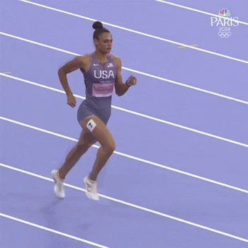 An Olympian jumping over hurdles.