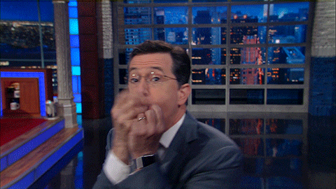 Stephen Colbert blowing air away from his hands and saying, "And it's gone."