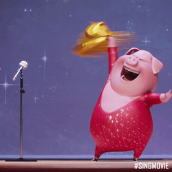 Gunter the pig waving a gold jacket above his head and belting a tune.
