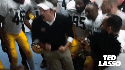 Scene from Ted Lasso with players and coach dancing