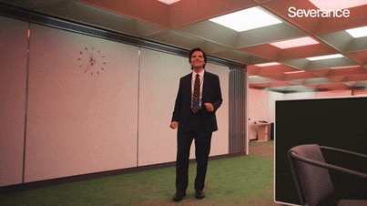 Character from TV show Severance dancing by himself in an office.